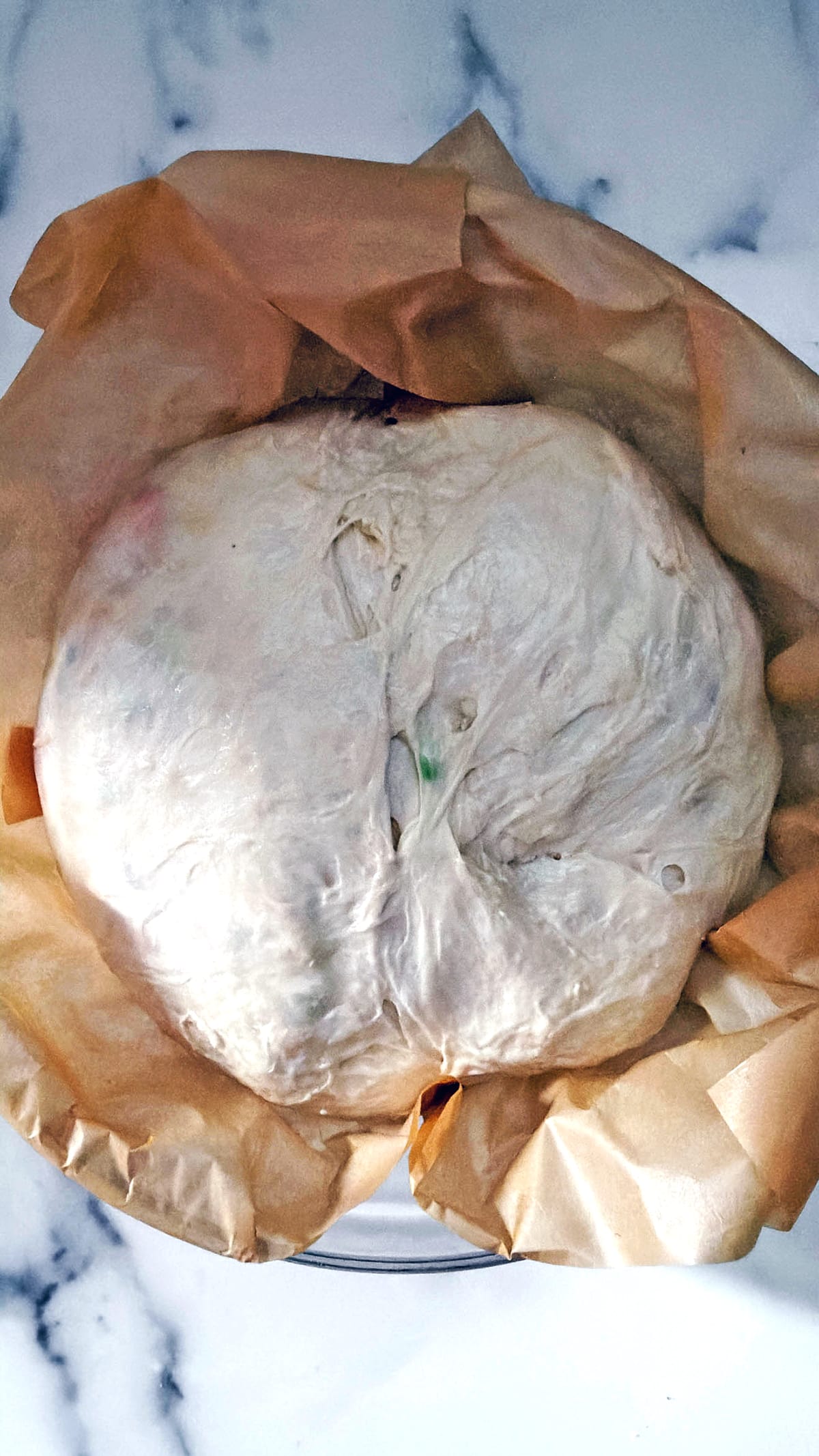 Overhead view of funfetti sourdough dough formed into ball.