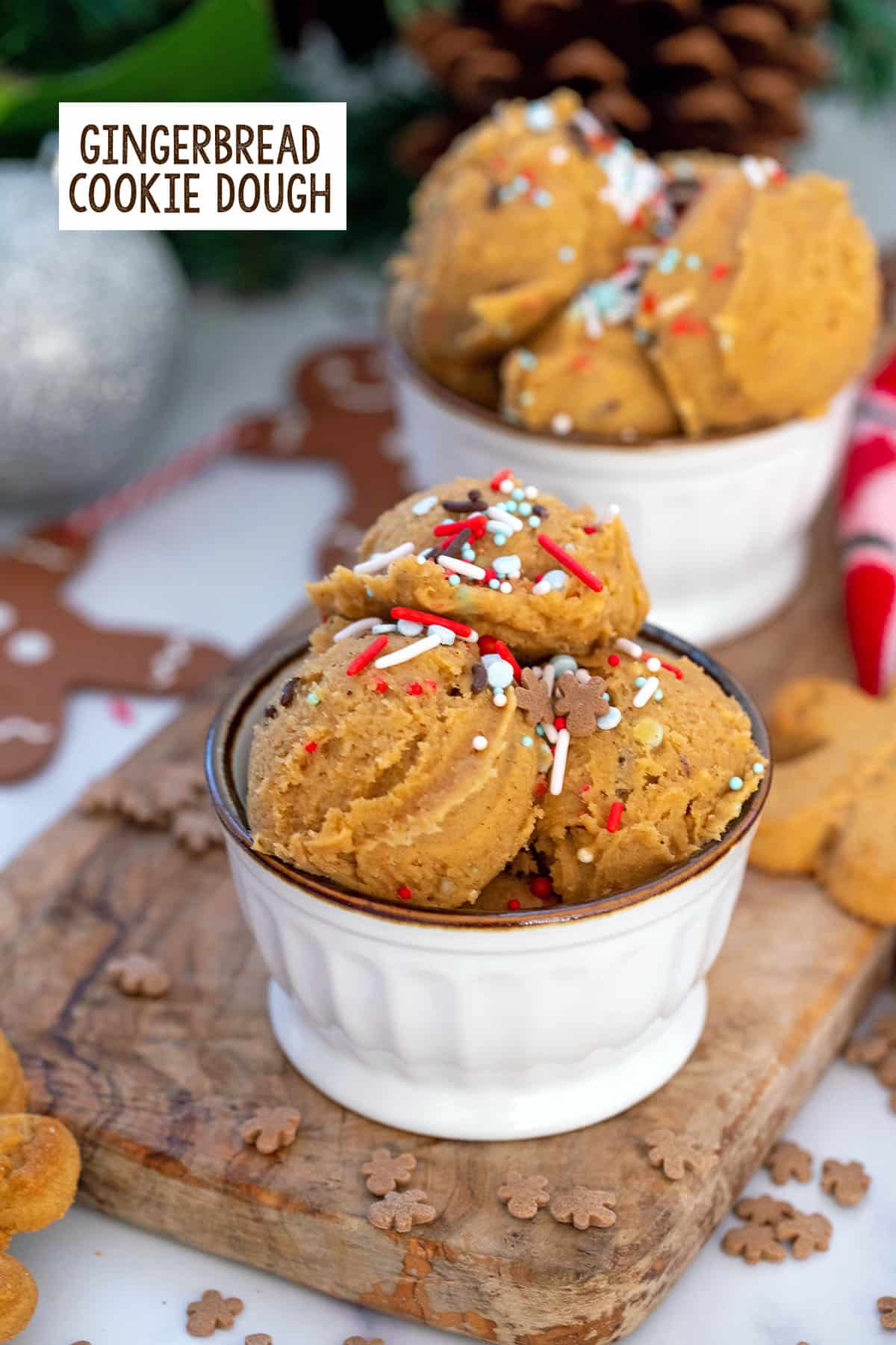 Small bowls filled with gingerbread cookie dough with sprinkles with recipe title at top.