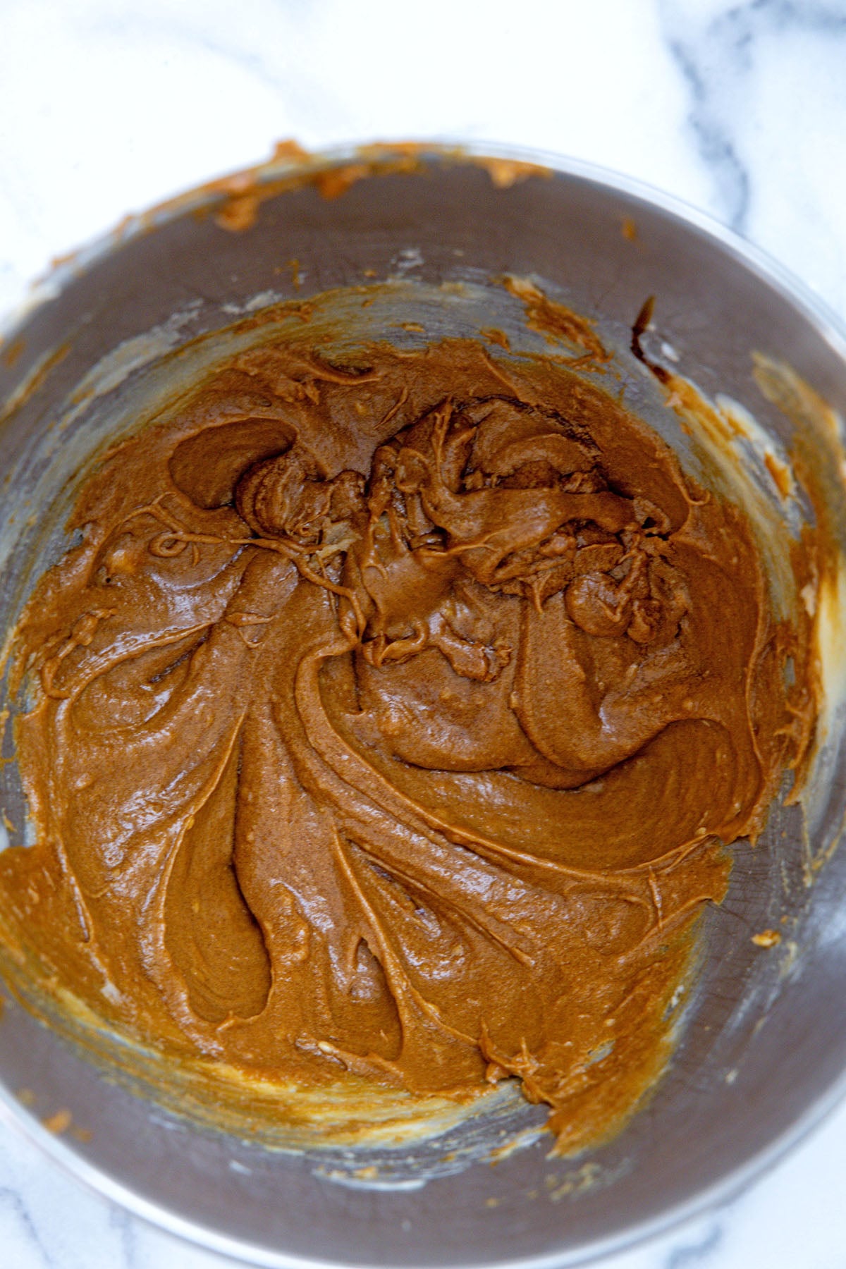 Gingerbread cookie batter in mixing bowl.
