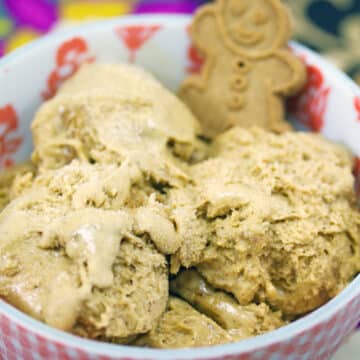 Closeup view of gingerbread ice cream in a bowl with a gingerbread man cookie.