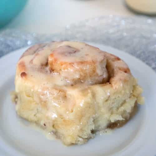 Closeup of a gingerbread roll topped with eggnog icing.