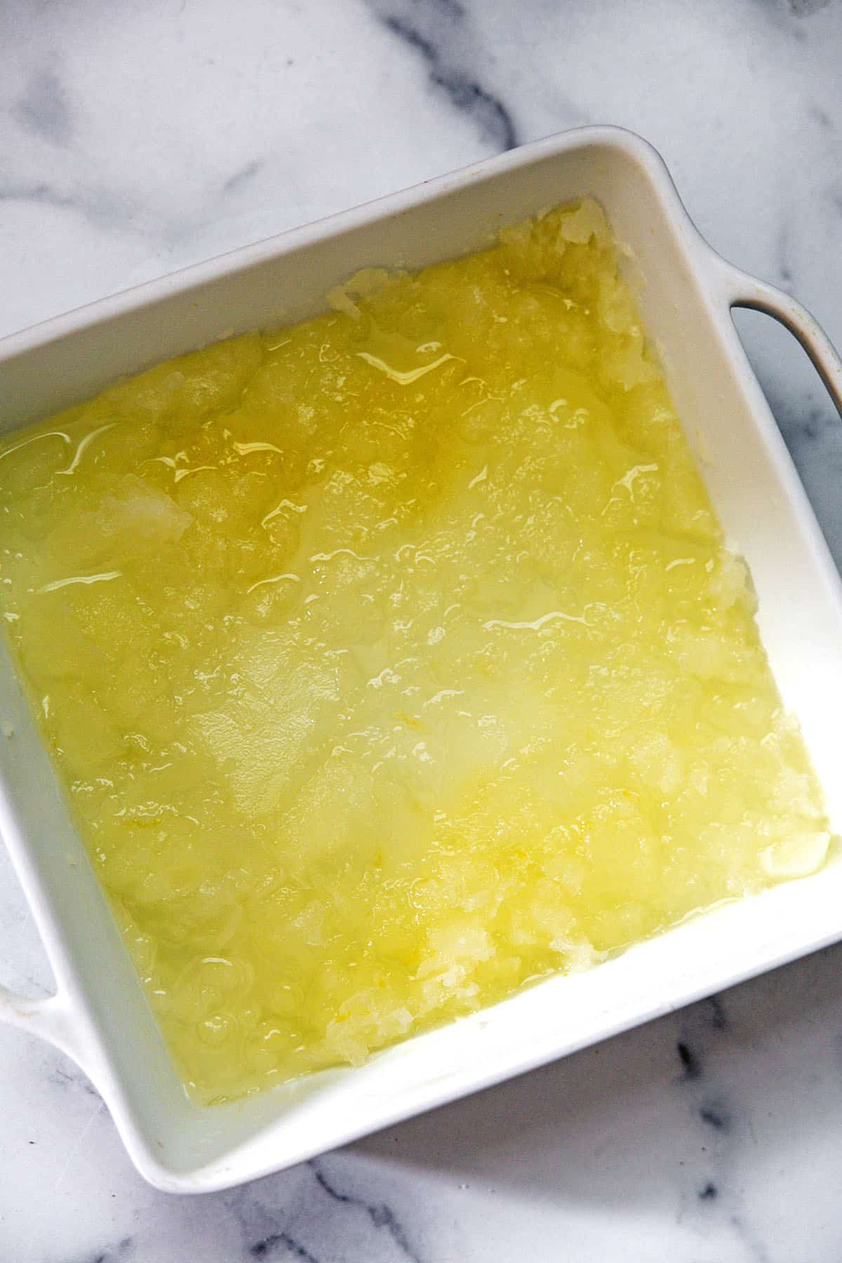 Baking dish with lemonade granita just starting to freeze.