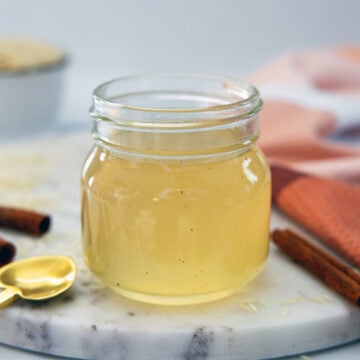 Closeup view of a small mason jar of horchata syrup.