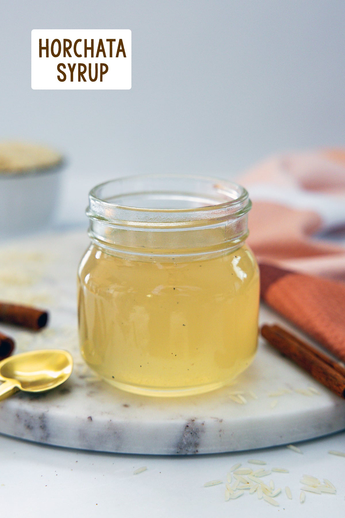 Head-on view of a small jar of horchata syrup with recipe title at top.