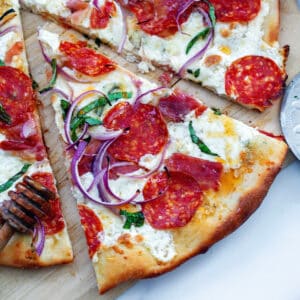 Closeup view of a slice of hot honey pizza.