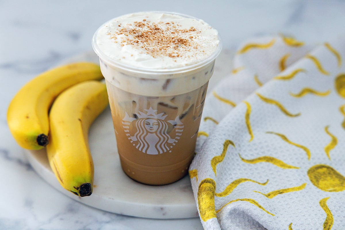 Landscape overhead view of an Iced Banana Bread Latte showing cinnamon sugar sprinkles on top.