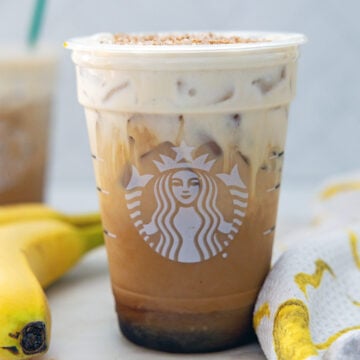 Closeup view of an Iced Banana Bread Latte in a Starbucks cup.