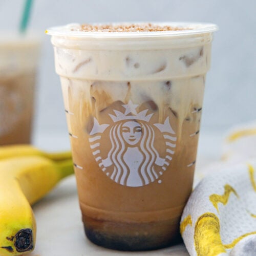Closeup view of an Iced Banana Bread Latte in a Starbucks cup.
