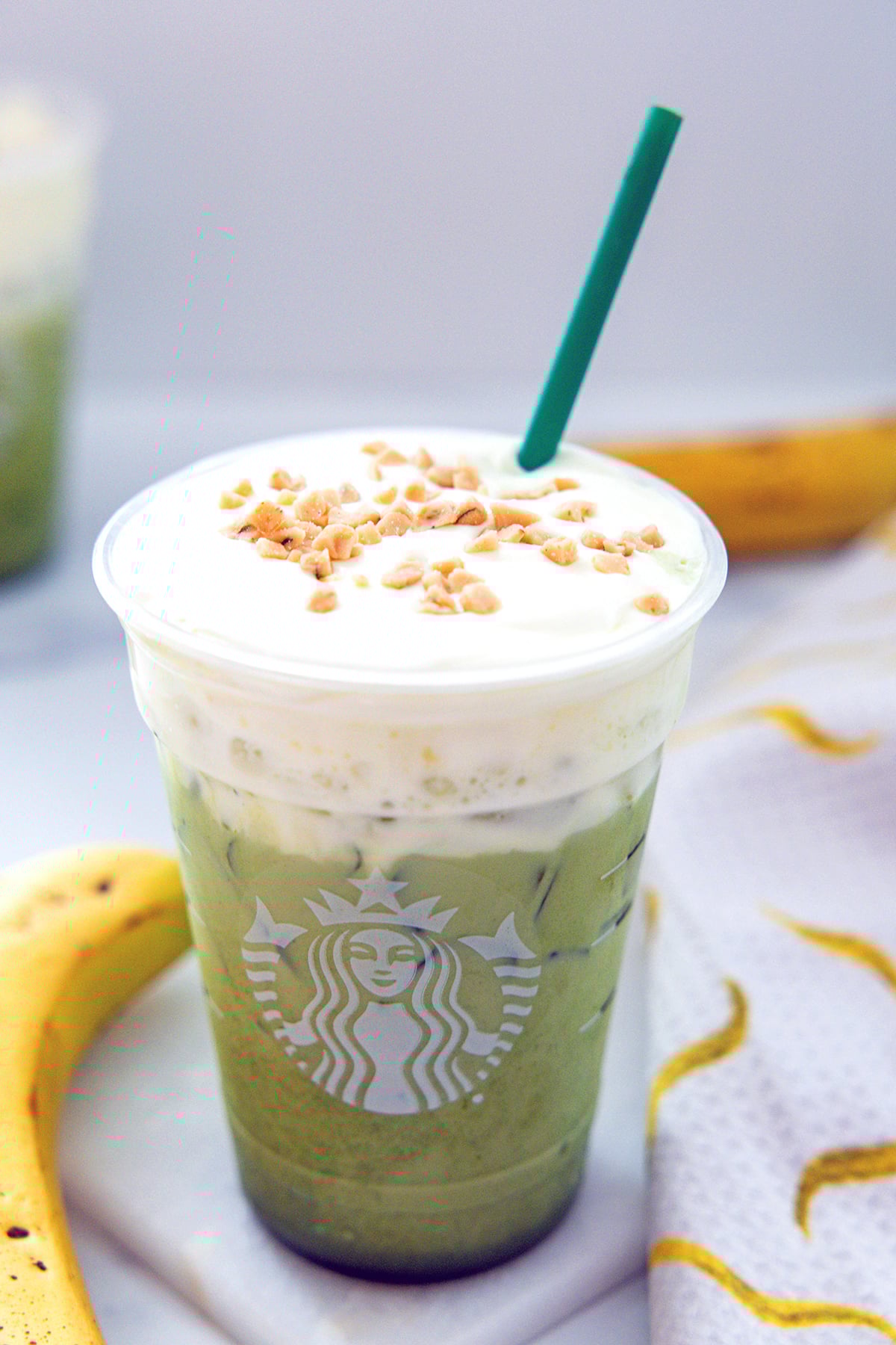 Overhead view of cold foam and caramel bits on top of Iced Banana Bread Matcha.