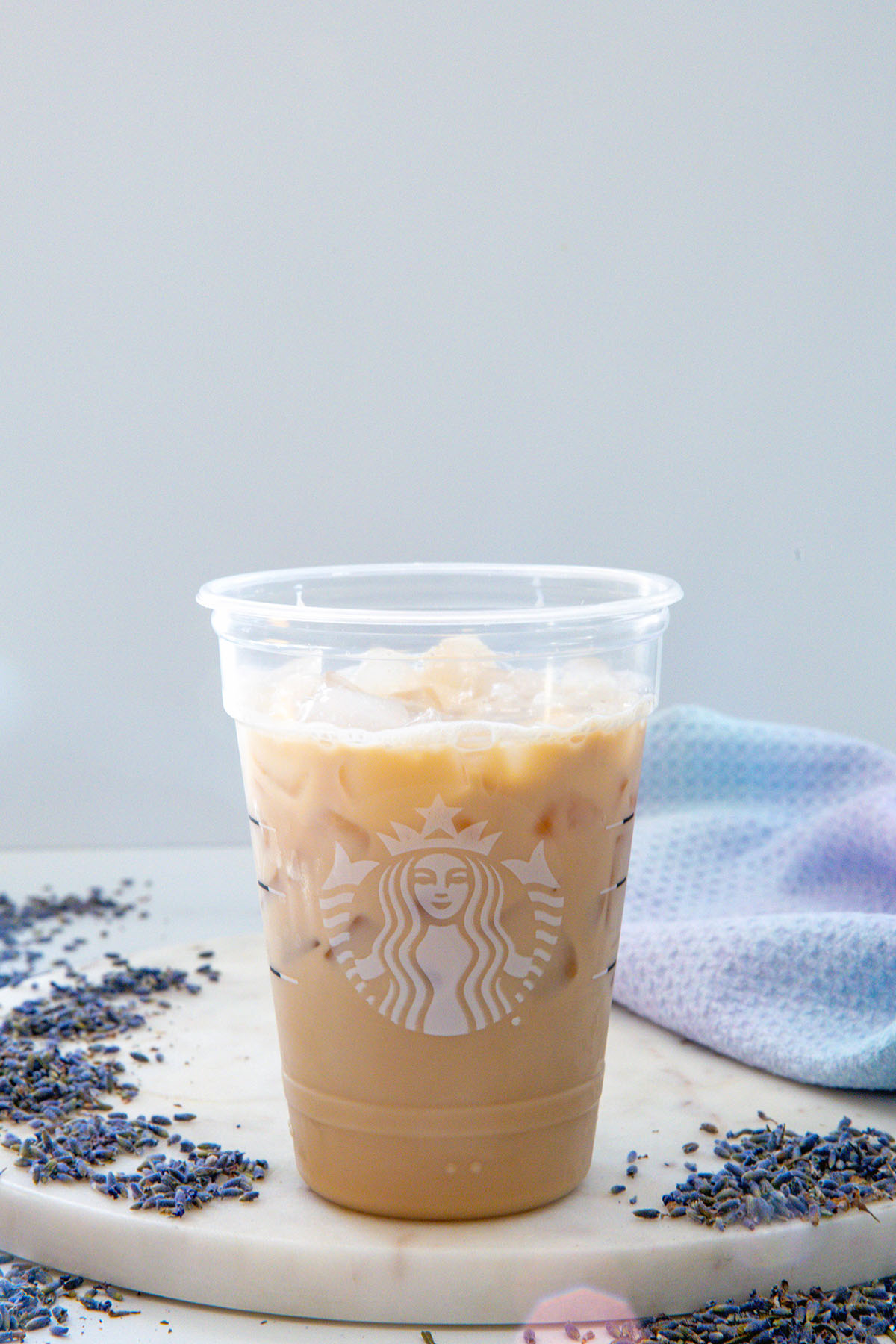 Iced chai concentrate mixed with milk in a Starbucks cup.