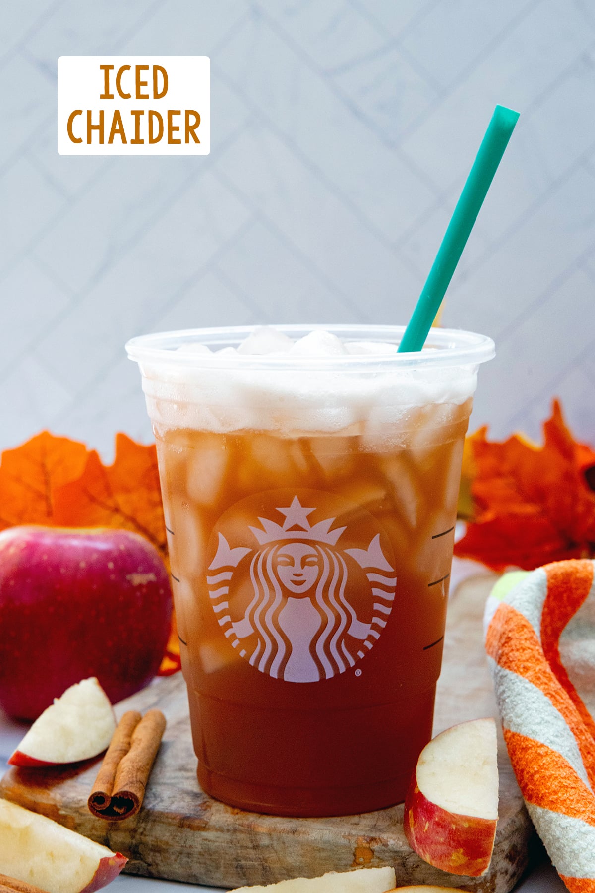 Head-on view of an Iced Chaider in a Starbucks cup with leaves and apples in background and recipe title at top.