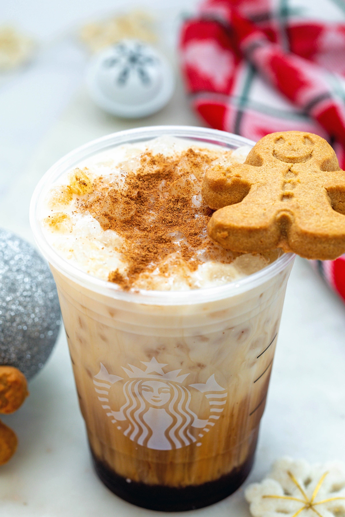 Overhead view of Iced gingerbread chai with gingerbread man cookie on top.