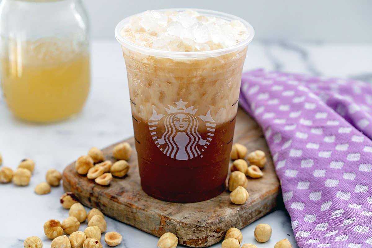 Overhead landscape view of an iced hazelnut oatmilk shaken epresso.