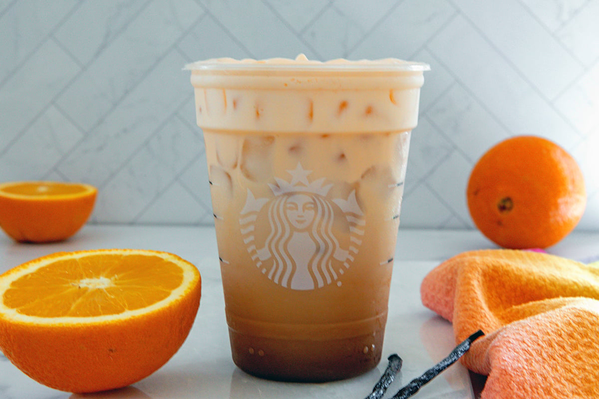 Iced Cream Cream Latte with slice oranges and vanilla beans all around.