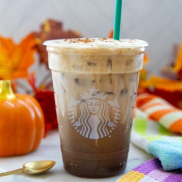 Closeup view of a Pumpkin Cream Shaken Espresso in a Starbucks cup.