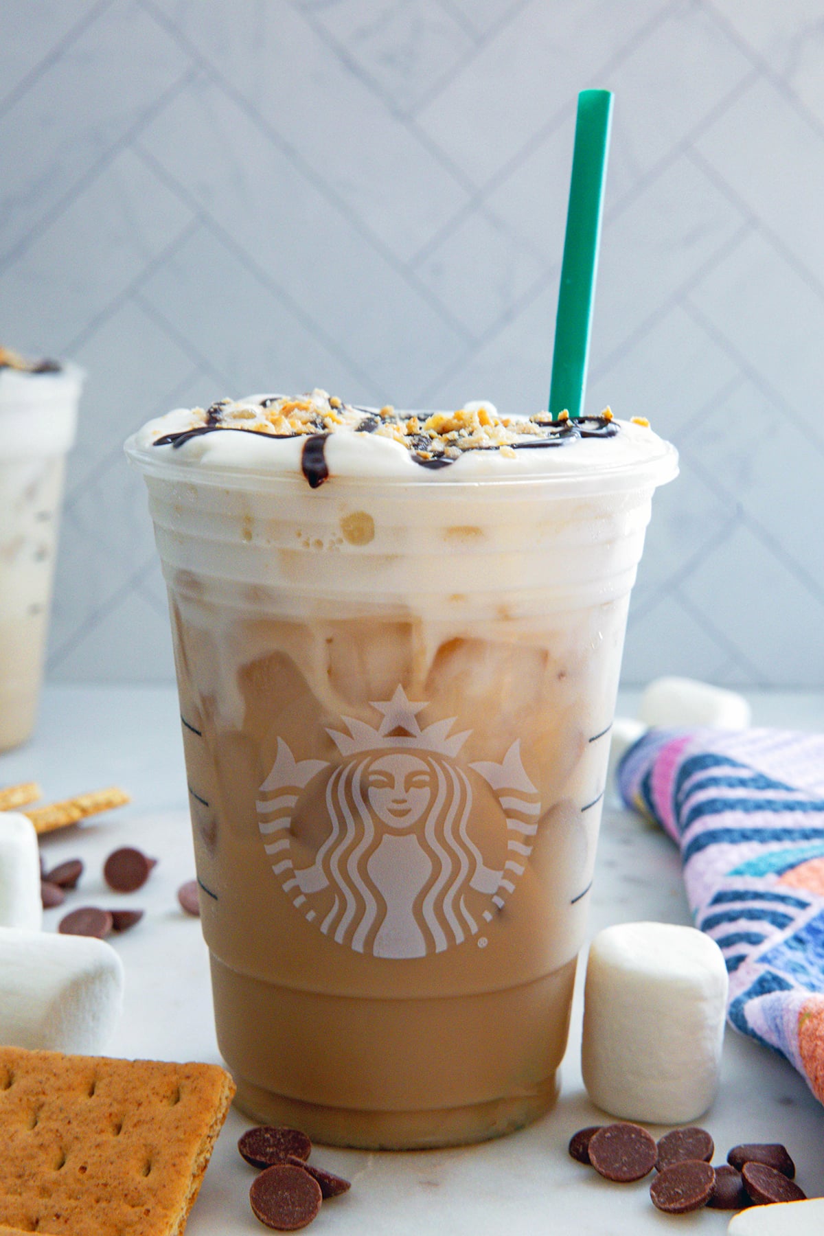 Head-on view of an Iced S'mores Chai with graham crackers, chocolate, and marshmallows all around.