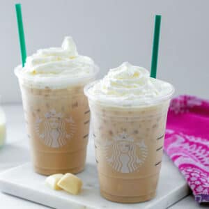 Two white chocolate mochas with whipped cream.