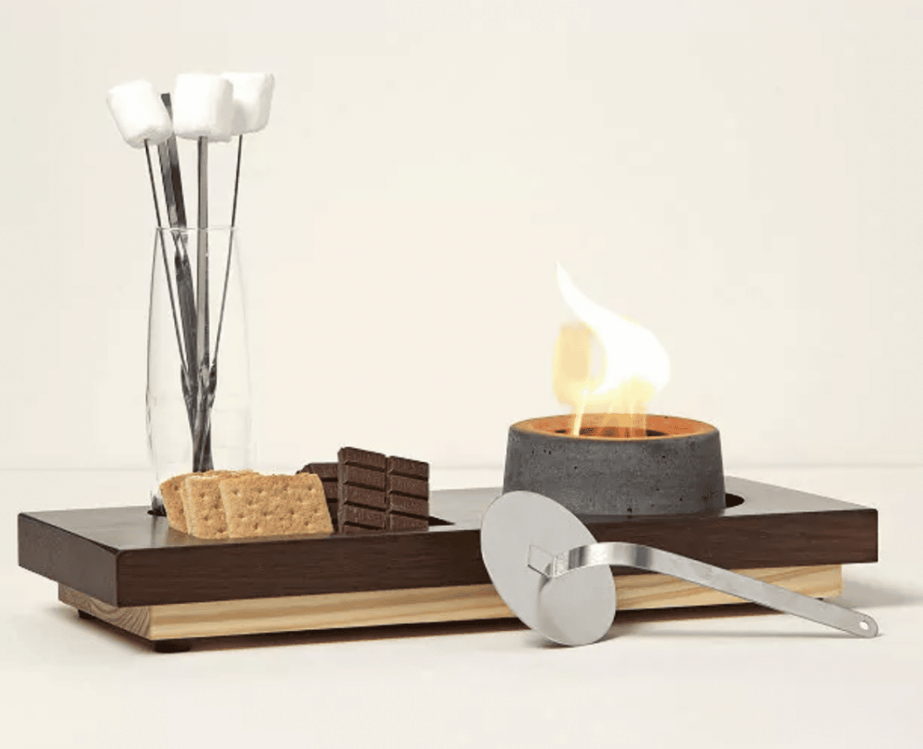 Indoor s'mores fire pit with marshmallows, graham crackers, and chocolate.