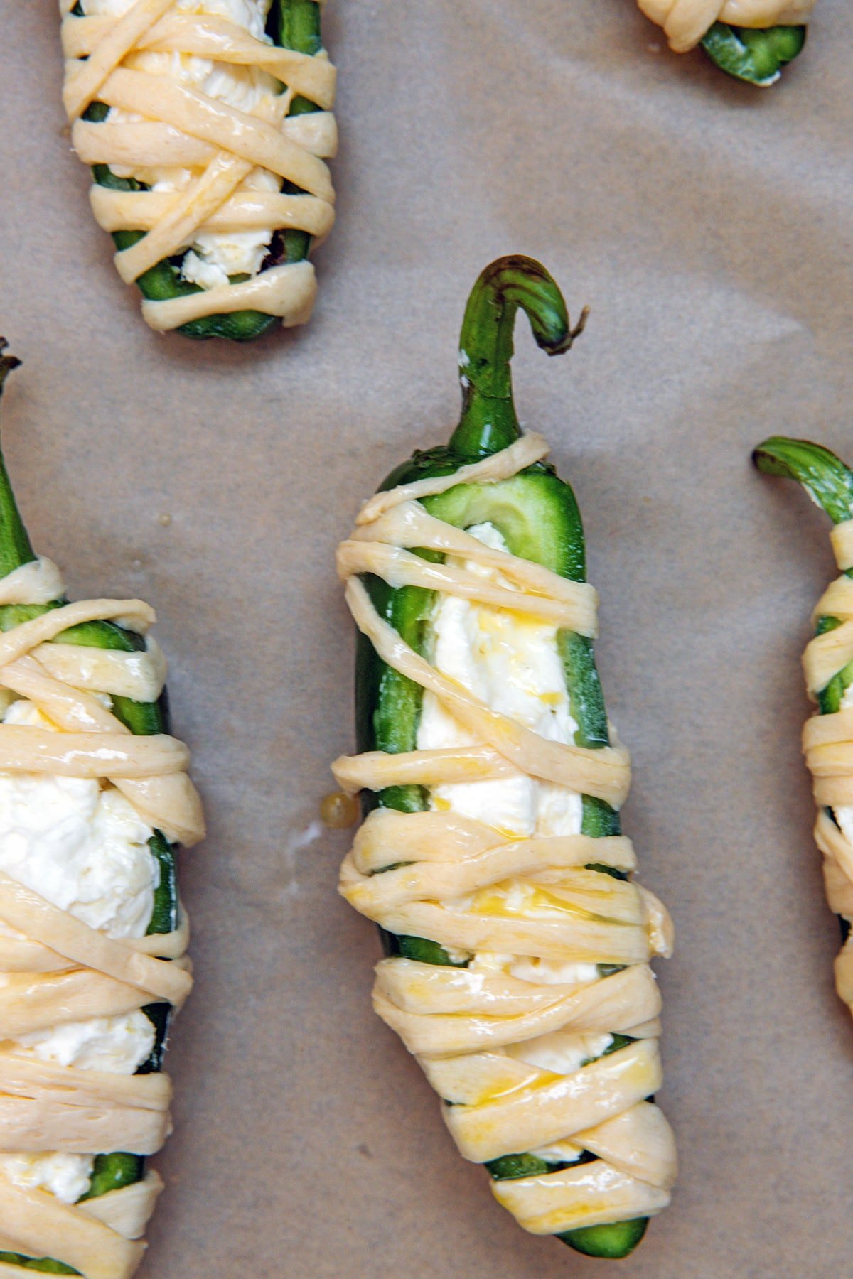 Jalapeño half stuffed with cream cheese and shredded cheese mixture and wrapped with phyllo dough.