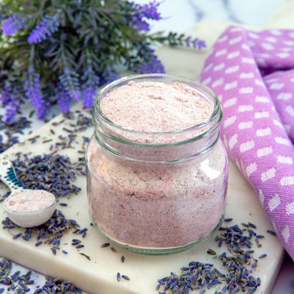 Closeup of a small jar of lavender powder.