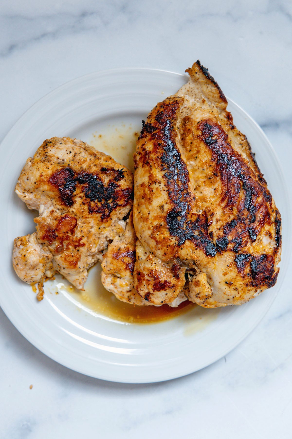 Grilled chicken breasts on a plate.