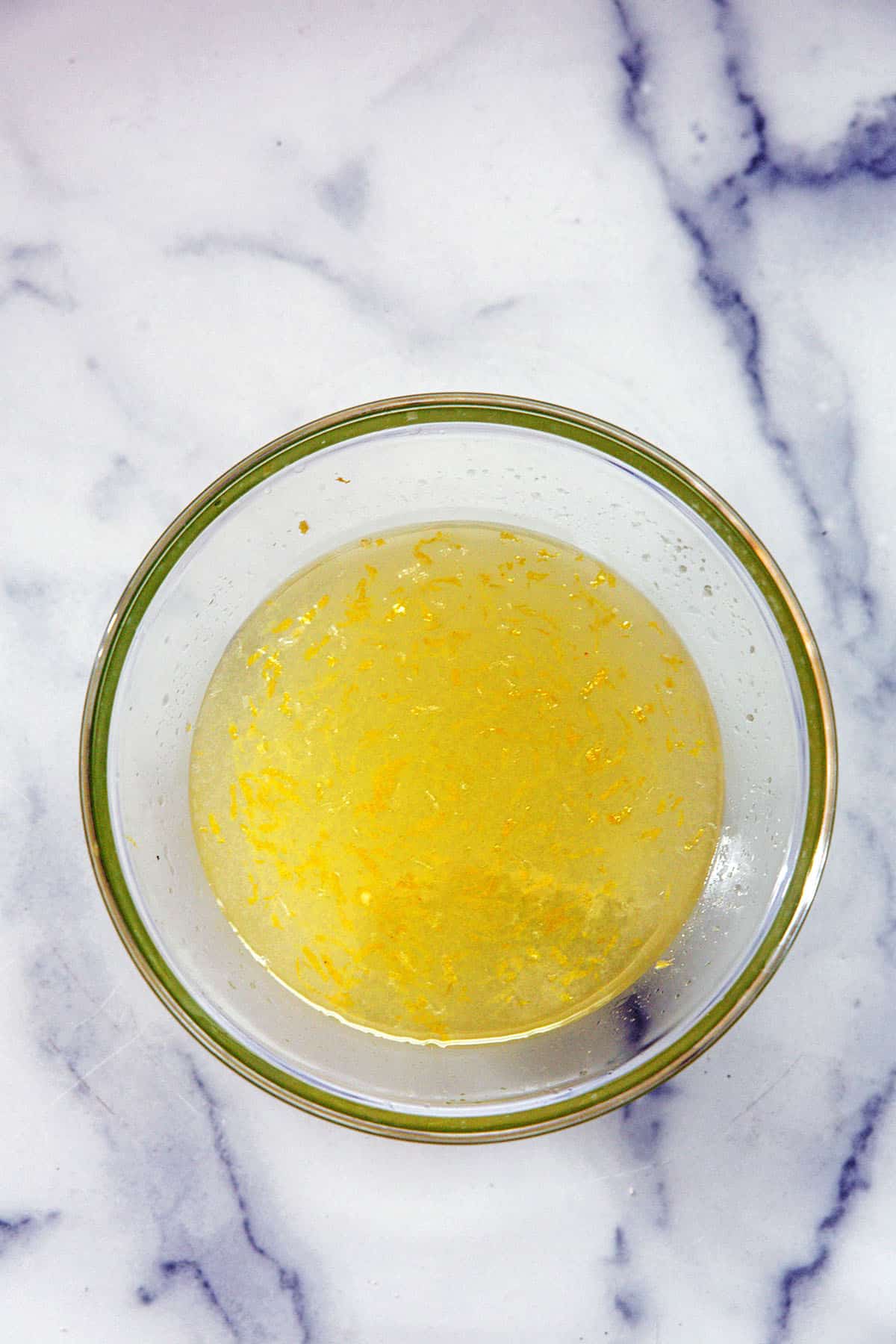 Lemon juice and simple syrup mixed together in bowl.