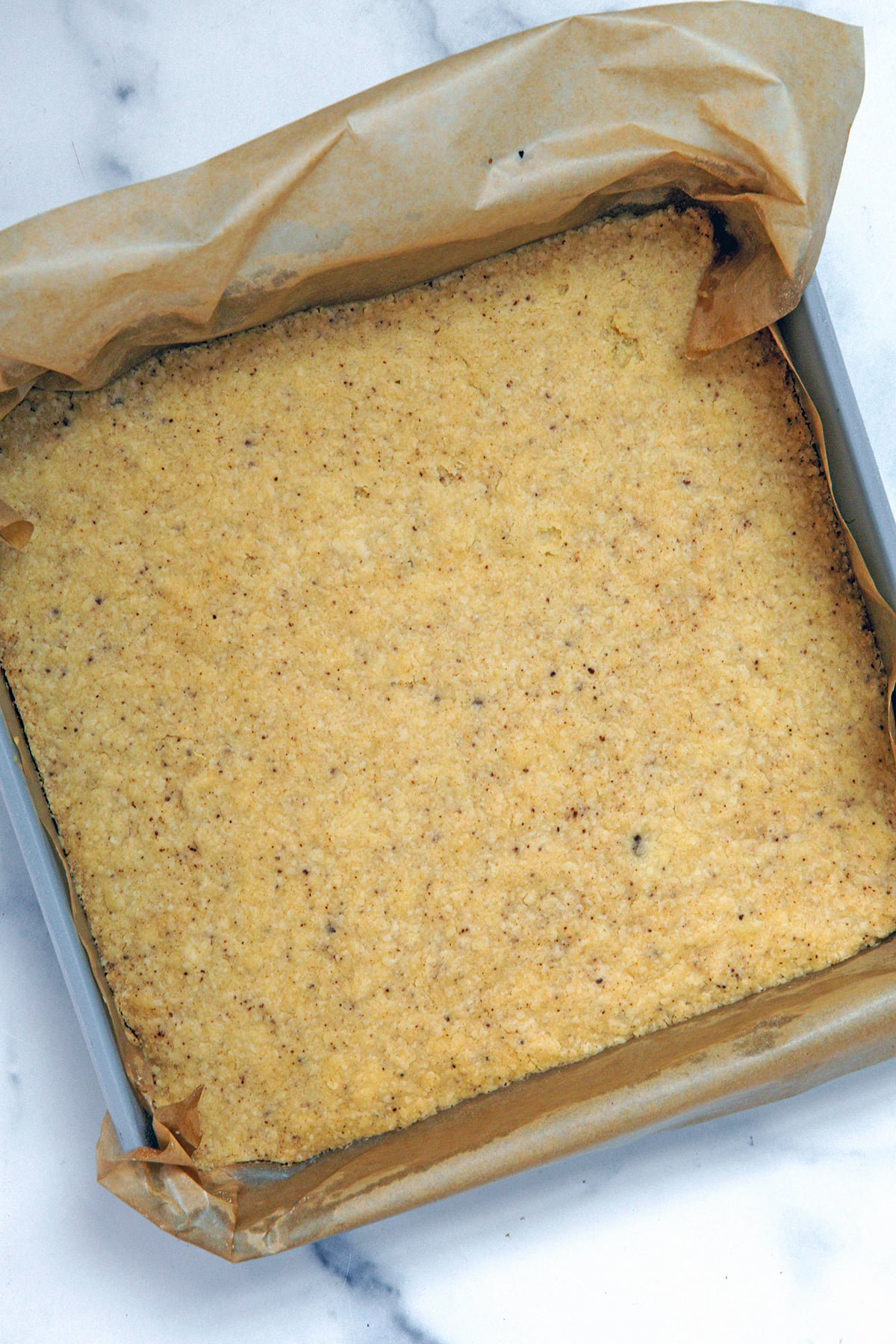 Brown butter shortbread crust baked in pan.