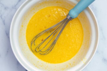 Lemon filling in mixing bowl with whisk.
