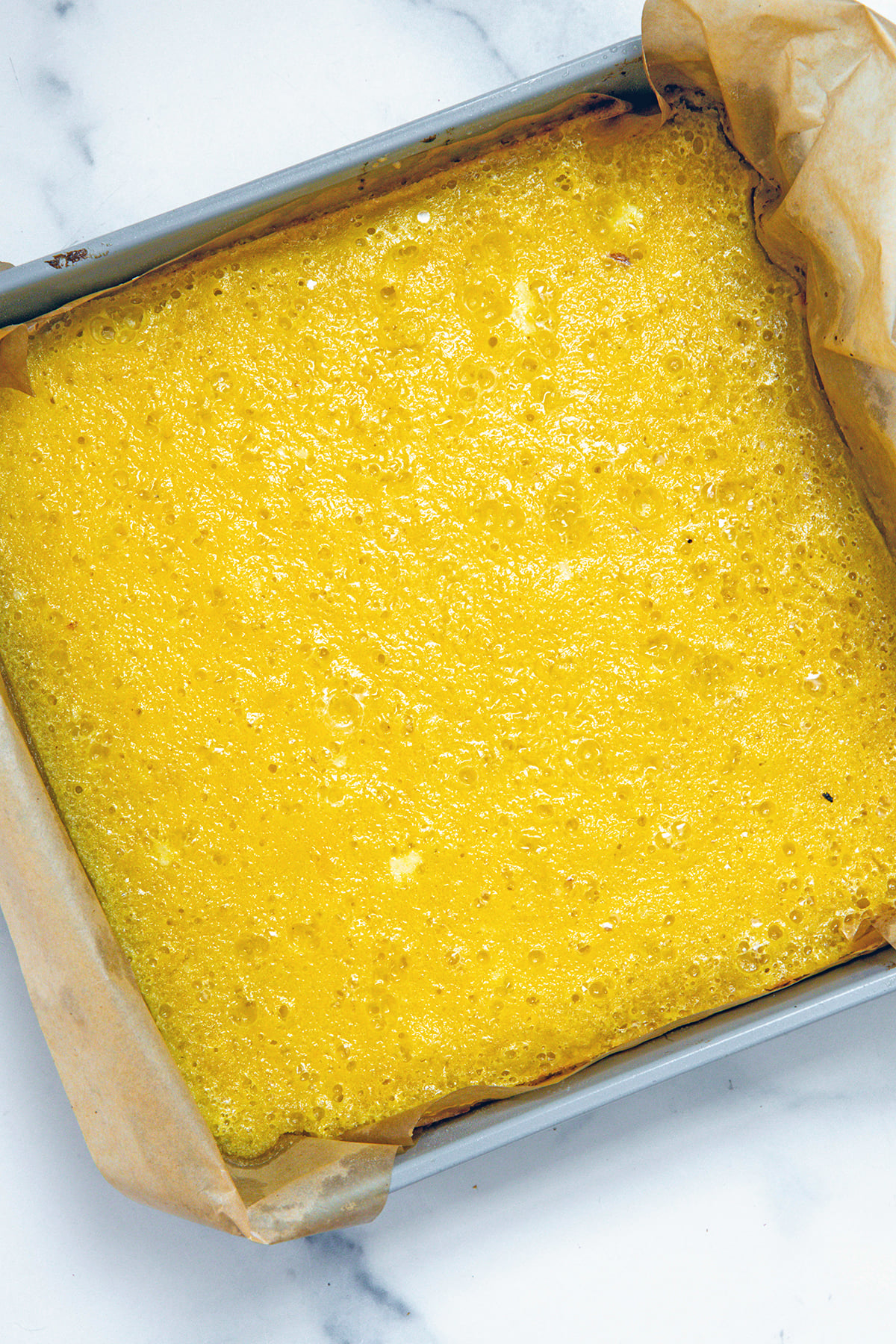 Cooked lemon filling in crust in pan.