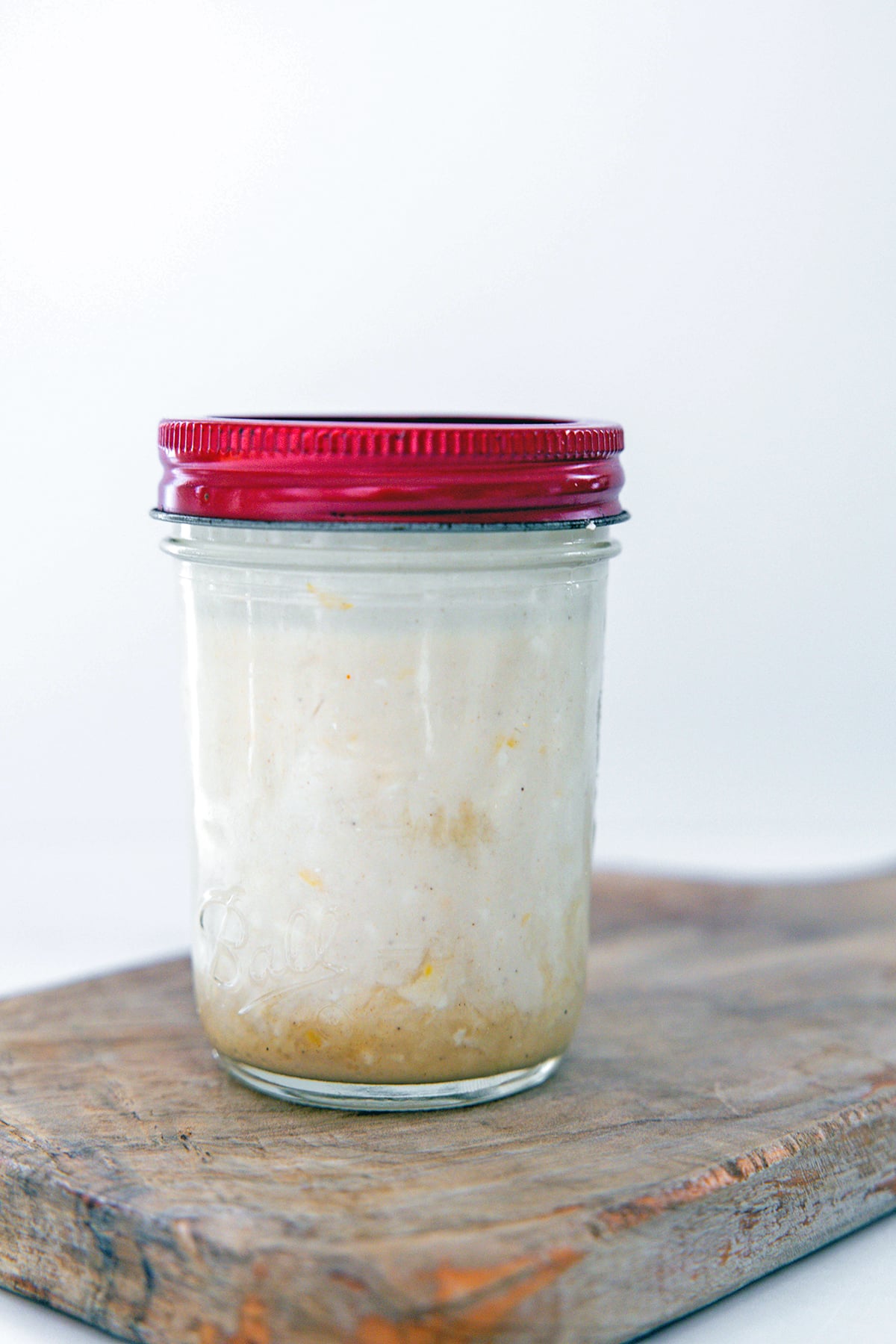Lemon tahini dressing in mason jar.