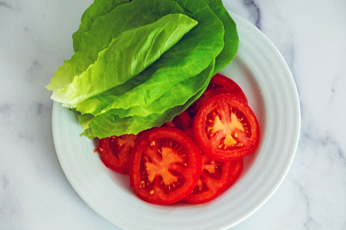 Lettuce and tomatoes on a plate.