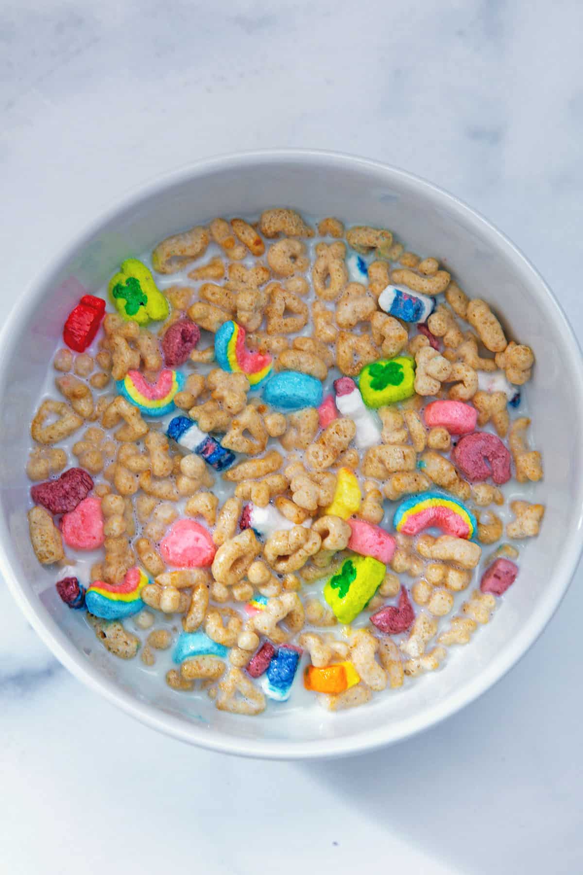 Lucky Charms cereal and milk in bowl.