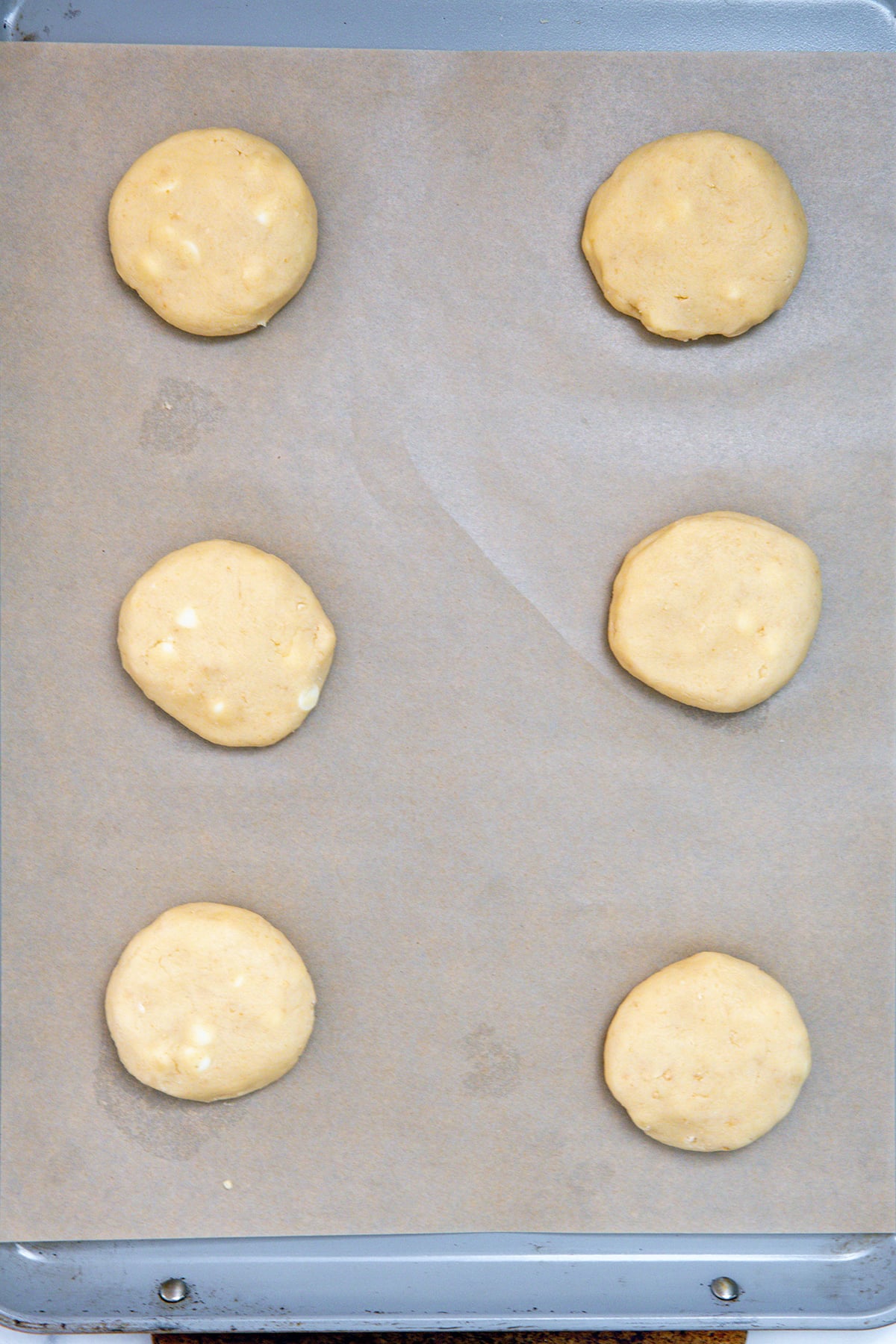 Lucky charms cookie dough on a parchment-lined baking sheet.