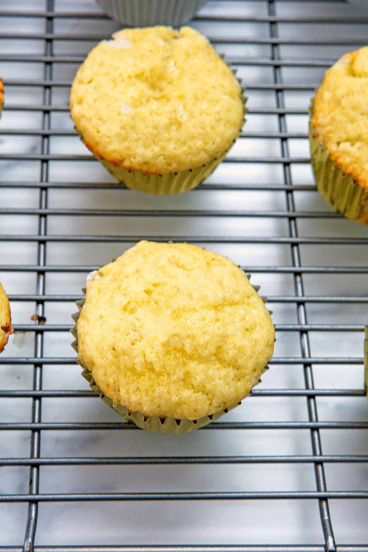 Cupcakes cooling on metal rack.