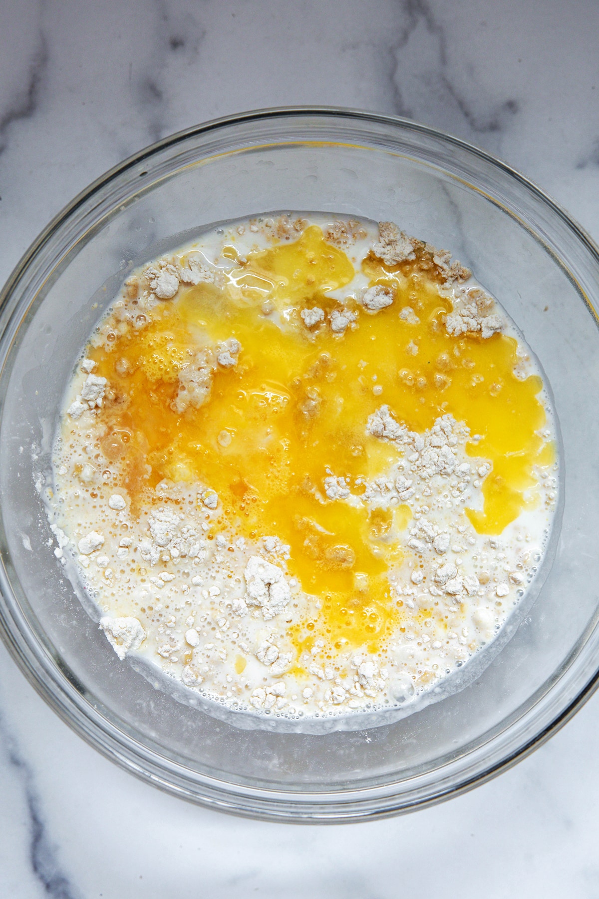 Mixing bowl with dry ingredients, milk, and eggs.