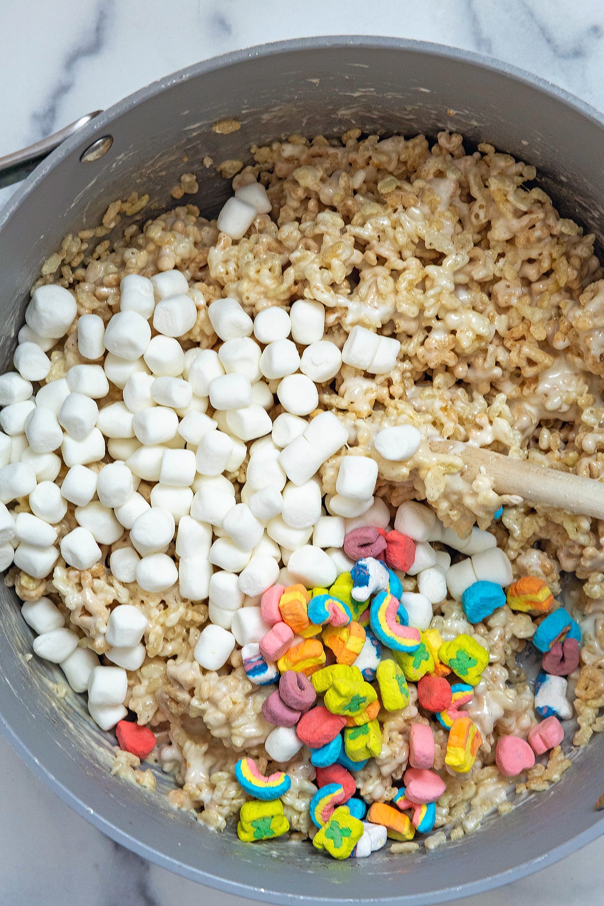 Rice Krispies and Lucky Charms oats marshmallow mixture with additional mini marshmallows and Lucky Charms marshmallows on top.