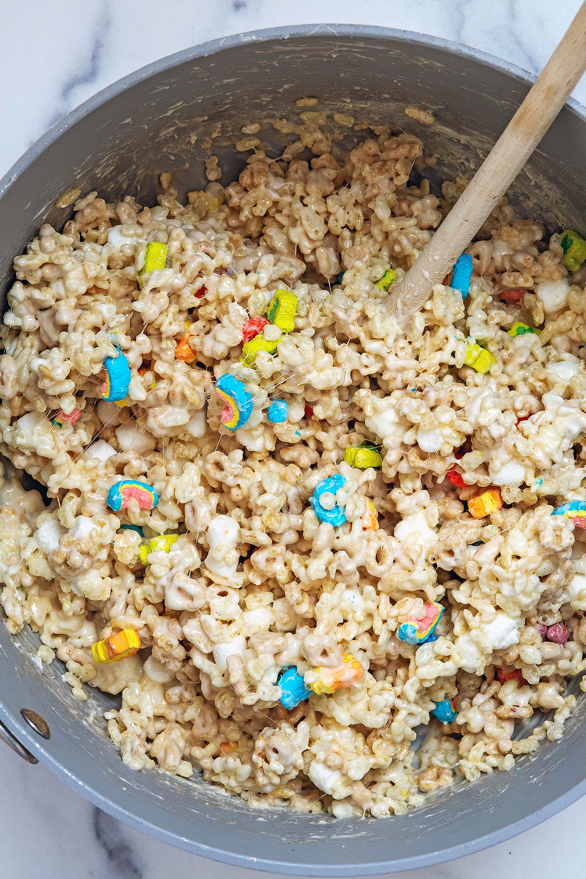 Lucky Charms rice krispie treats mixture in saucepan.