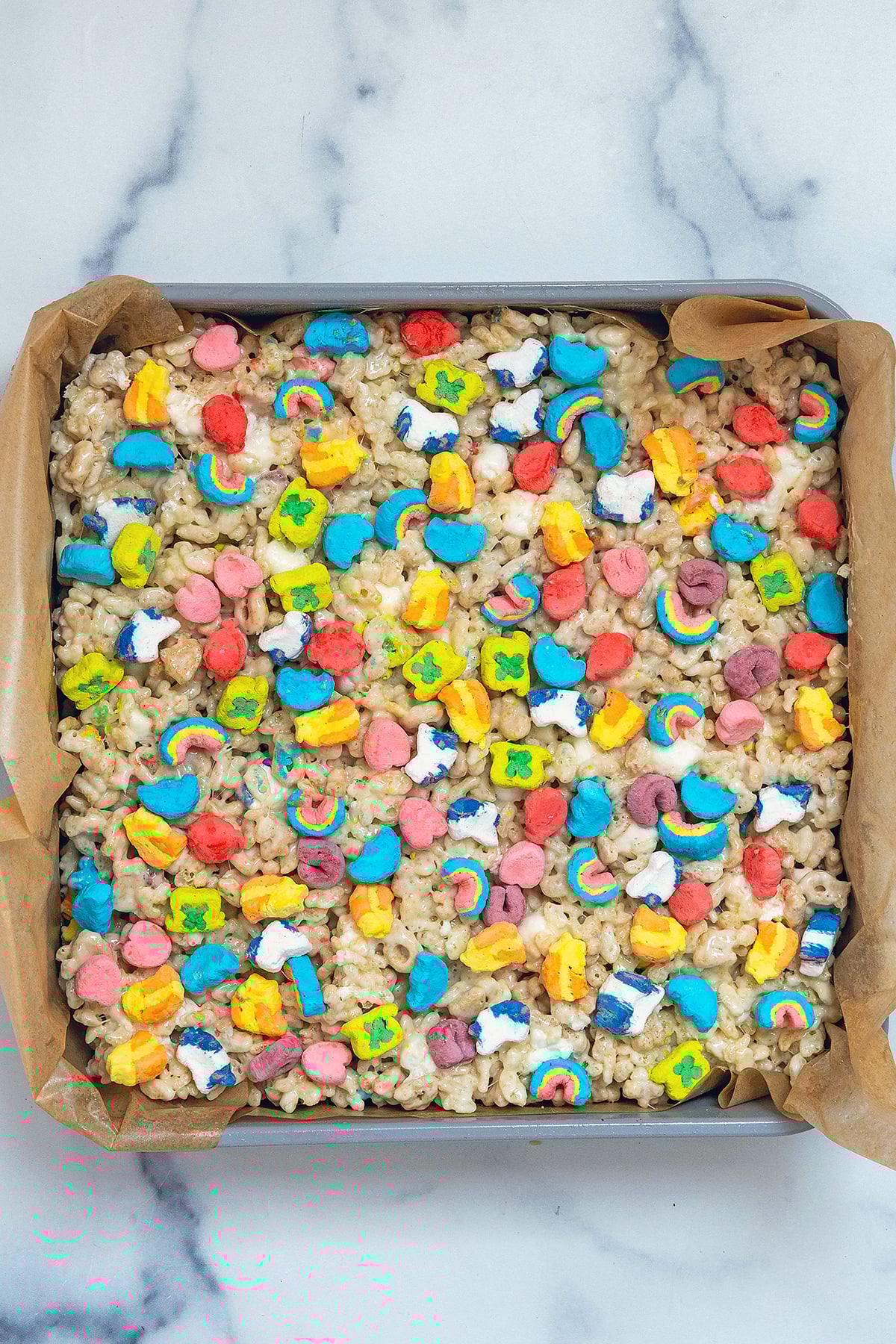 Lucky Charms rice krispies treats mixture pressed into baking pan.