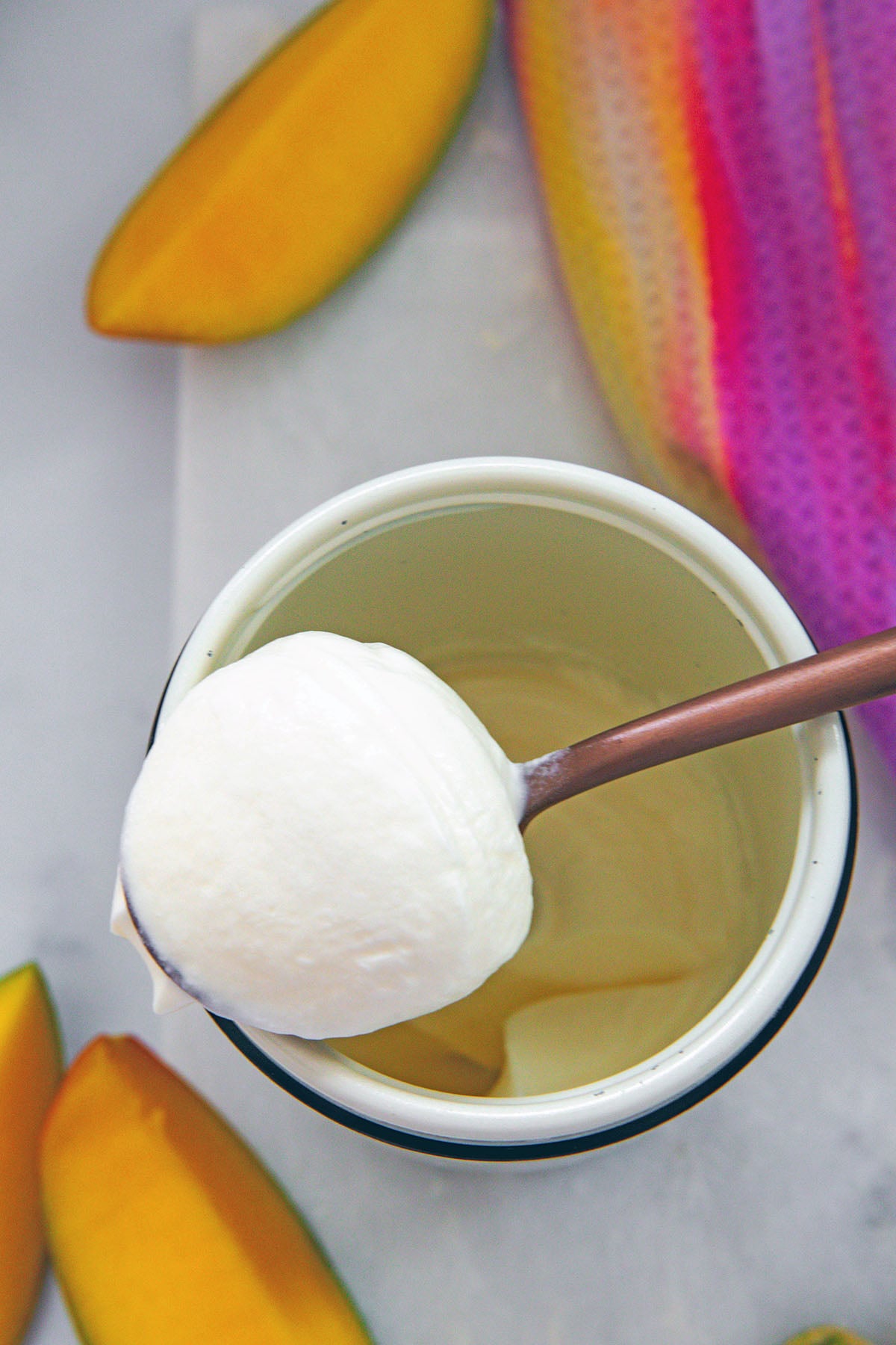 Overhead view of mango cold foam on a spoon.