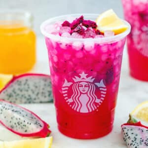 Closeup view of Mango Dragonfruit Lemonade in a Starbucks cup.