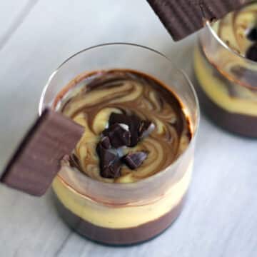 Overhead view of a marbled mint chocolate pudding in glass cup.