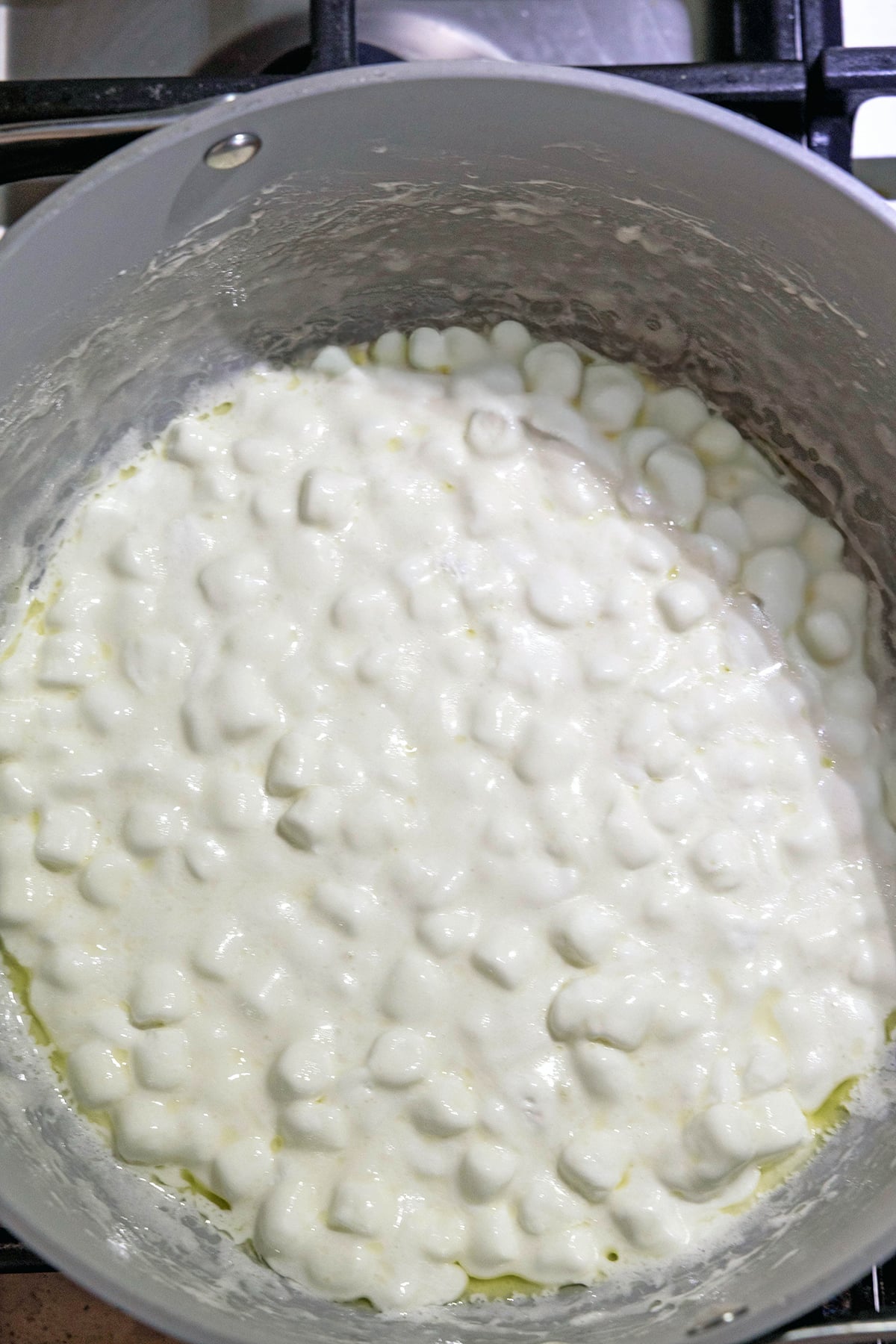 Marshmallows melting in a saucepan.