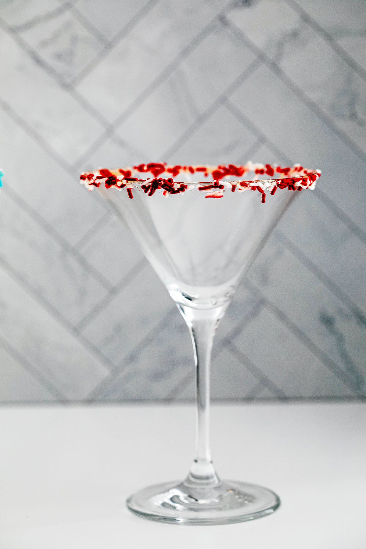 Martini glass with rim coated in sprinkles.
