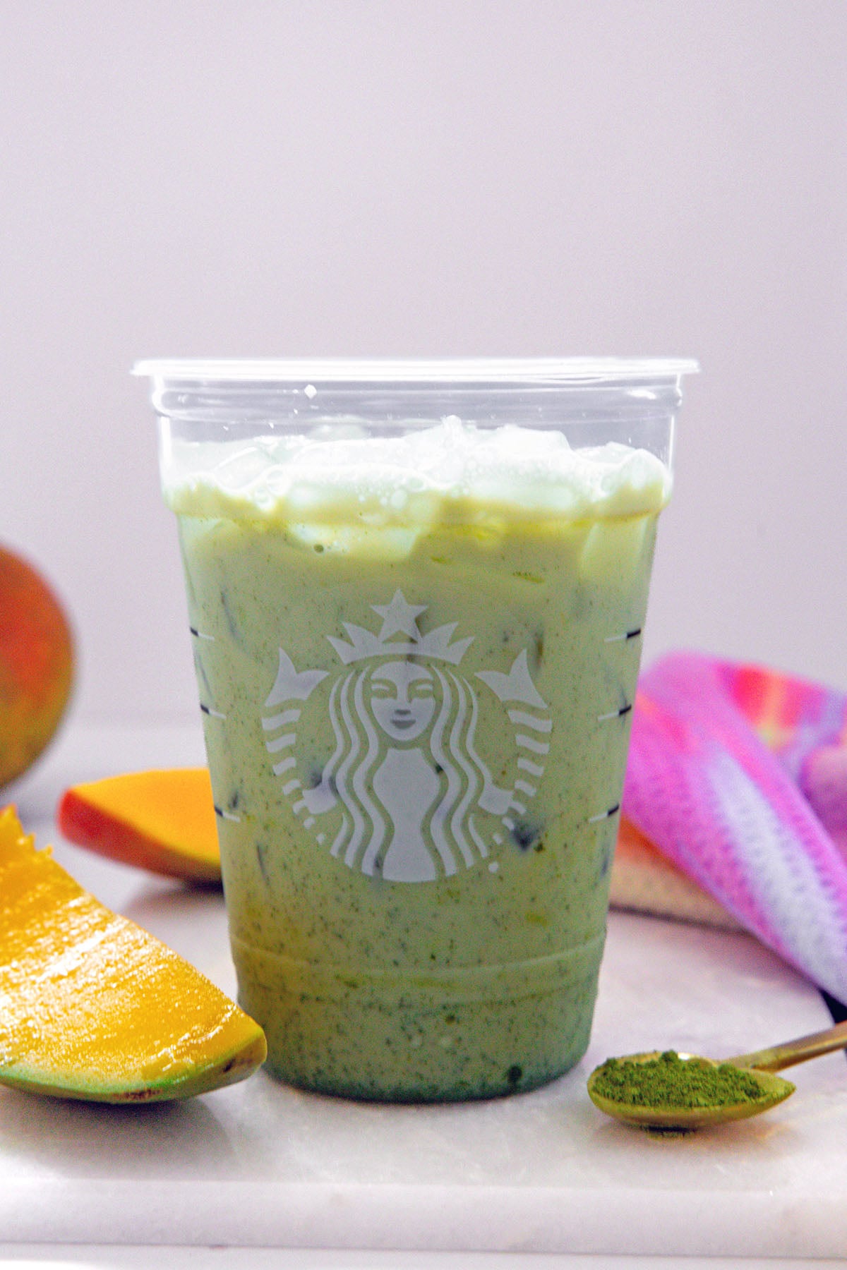 Matcha powder and milk mixed together in Starbucks cup.