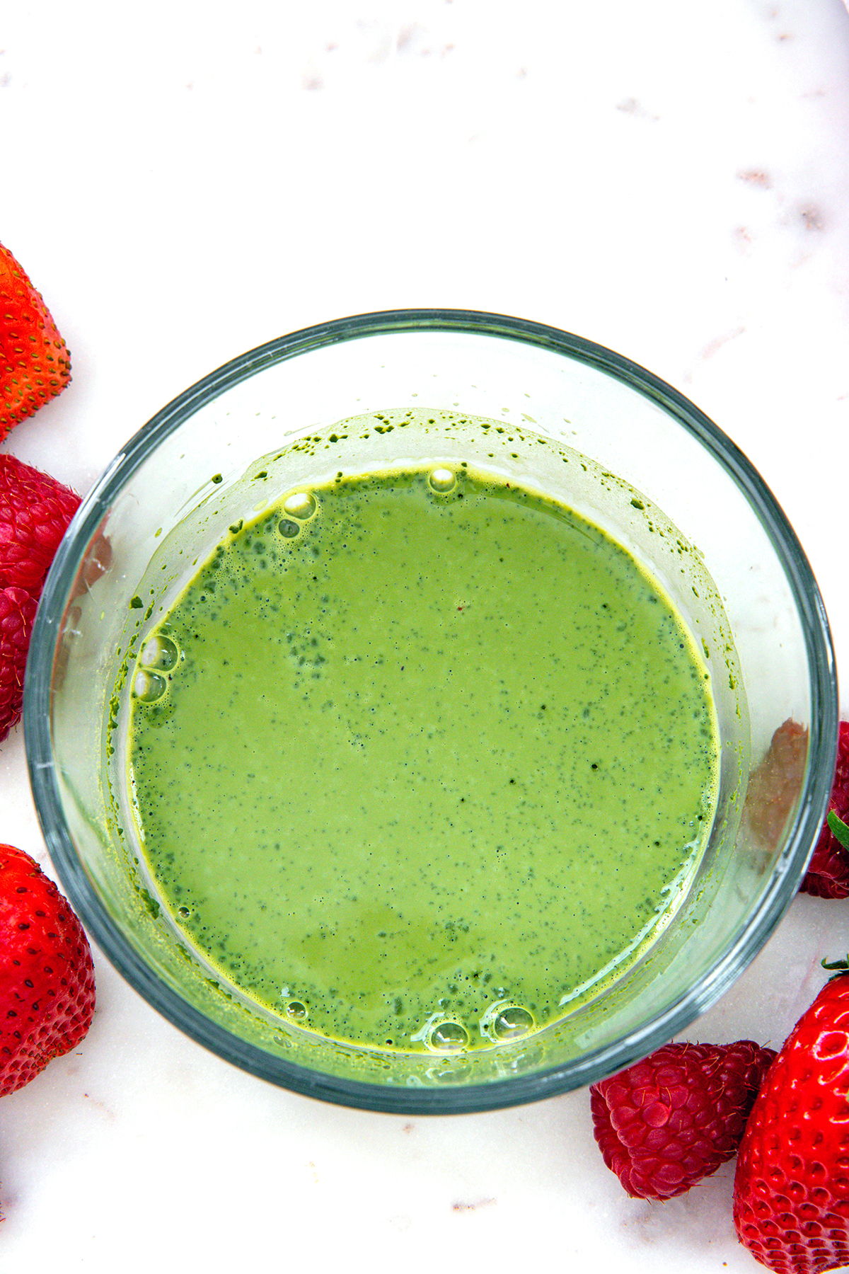 Matcha and milk mixed together in a small bowl.