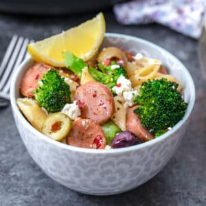 Closeup view of a bowl of Mediterranean broccoli and chicken sausage pasta.