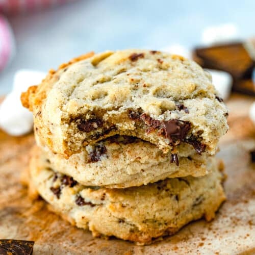 Closeup view of a stack of Mexican chocolate cookies on a wooden board.