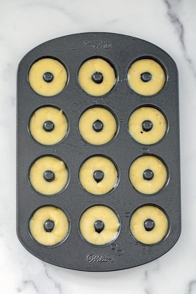 Overhead view of mini donut pan with batter in it.