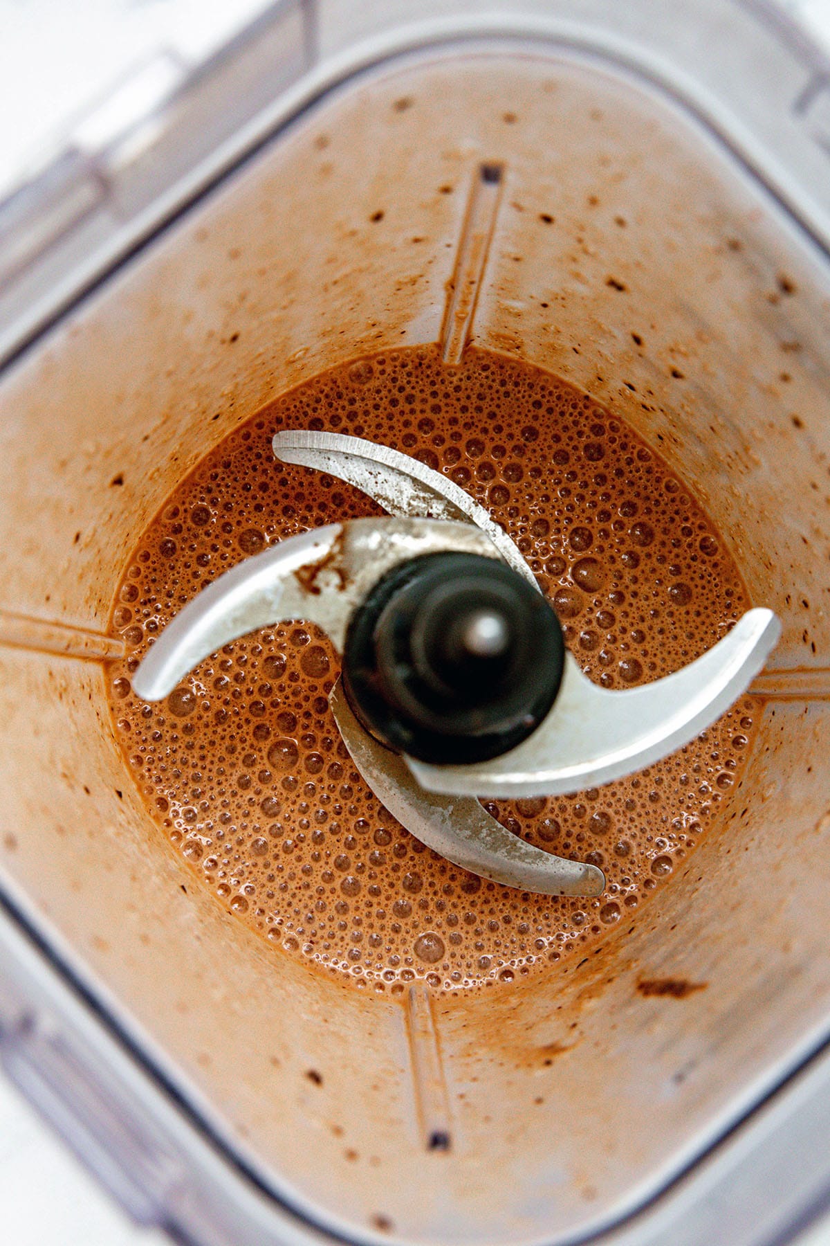 Overhead view of Frappuccino ingredients blended together in blender.