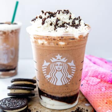 Closeup view of a Mocha Cookie Crumble Frappuccino with whipped cream and mocha sauce drizzle.